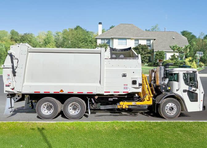 Heil DuraPack Python side load garbage truck collecting carts curbside